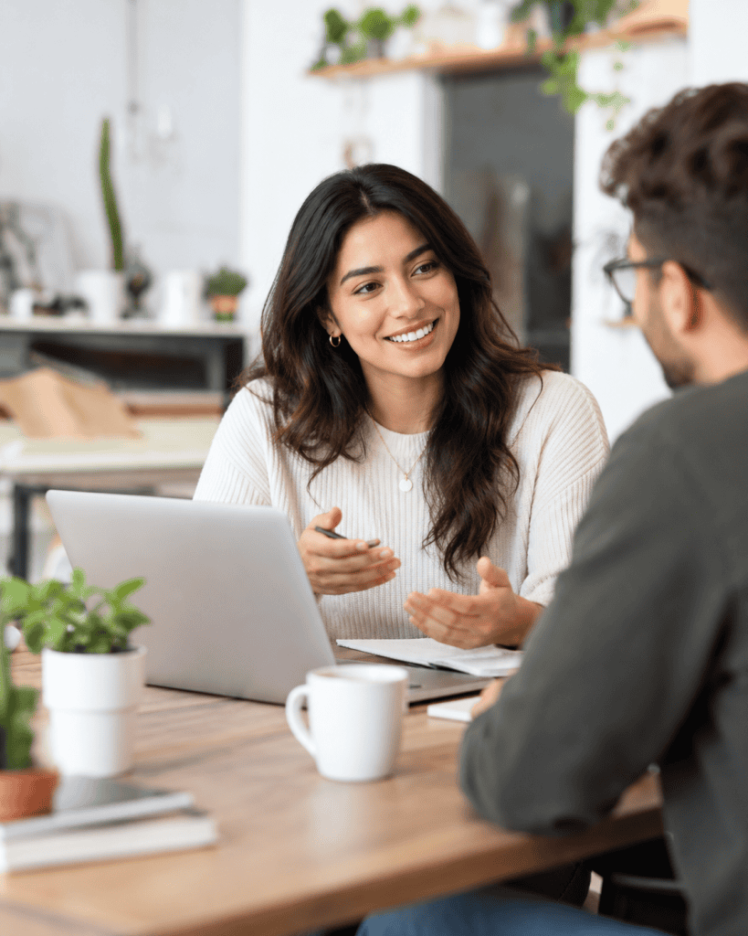 Two professionals having a discussion in a modern office.